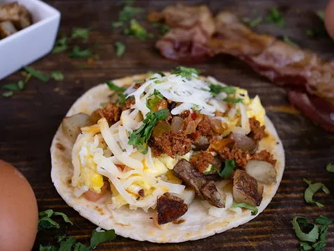 Breakfast taco with chorizo, egg, potato, cheese and cilantro at Cinco Más