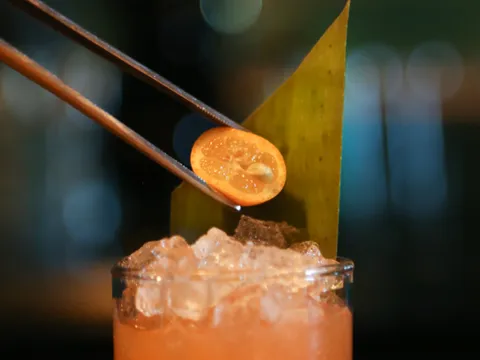 Orange cocktail being garnished at Zola and BarZola