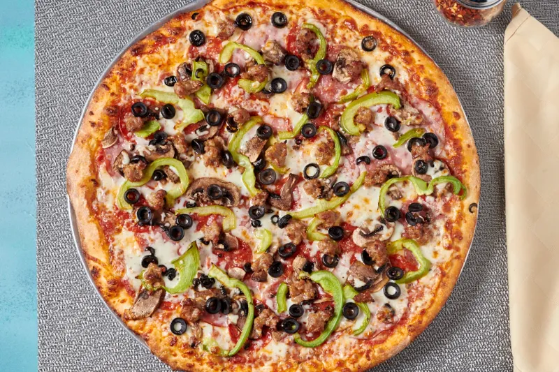 New York Pizza combination pizza with meats, olives, mushrooms and peppers