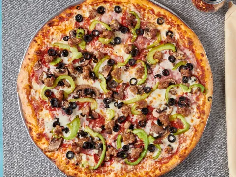 New York Pizza combination pizza with meats, olives, mushrooms and peppers