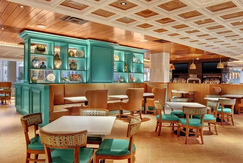 Turquoise and warm wood dining room at Sabor in El Paso