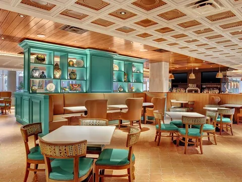 Turquoise and warm wood dining room at Sabor in El Paso