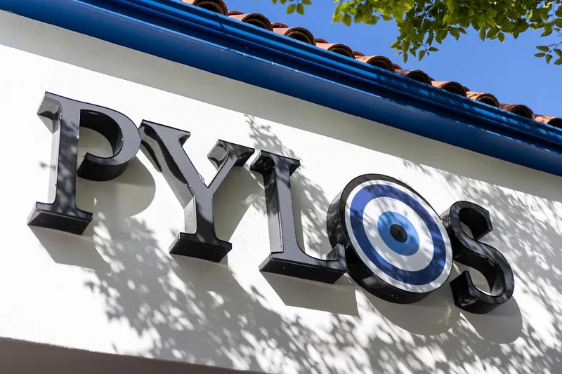 Pylos restaurant sign and tiled roof in San Carlos