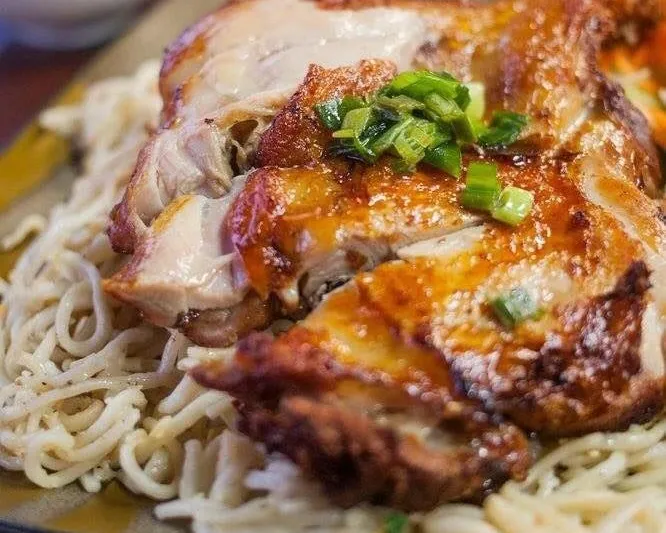 Ben Tre five-spice chicken served over garlic noodles