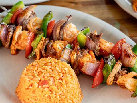 Grilled shrimp skewers with peppers, onions and rice at Guads