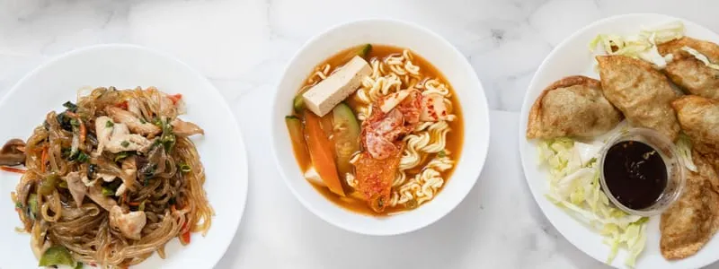 Japchae, tteokbokki, and dumplings served at Minari