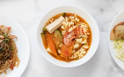 Japchae, tteokbokki, and dumplings served at Minari