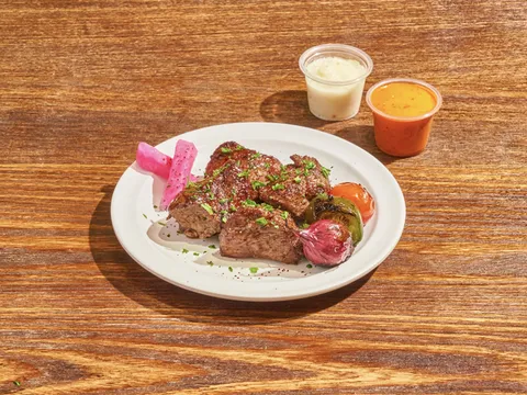 Mazra lamb kebab with grilled vegetables, pickled turnips, and two sauces