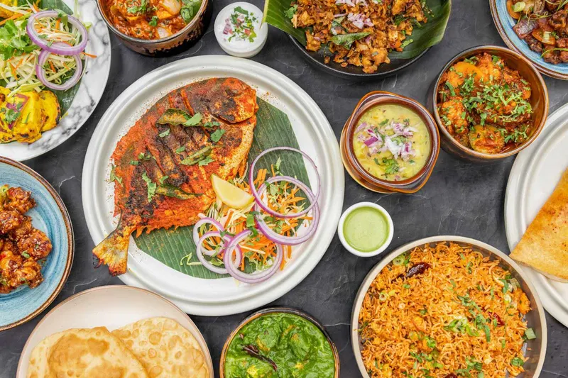 Overhead spread of South Indian dishes, breads and chutneys at Sangamam