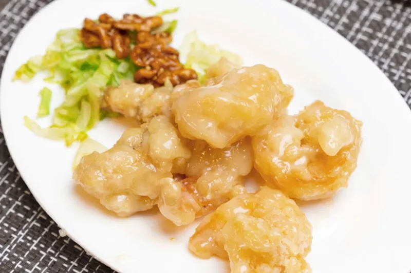 Plate of honey walnut prawns with candied walnuts and shredded lettuce at Harbor City Restaurant Tacoma