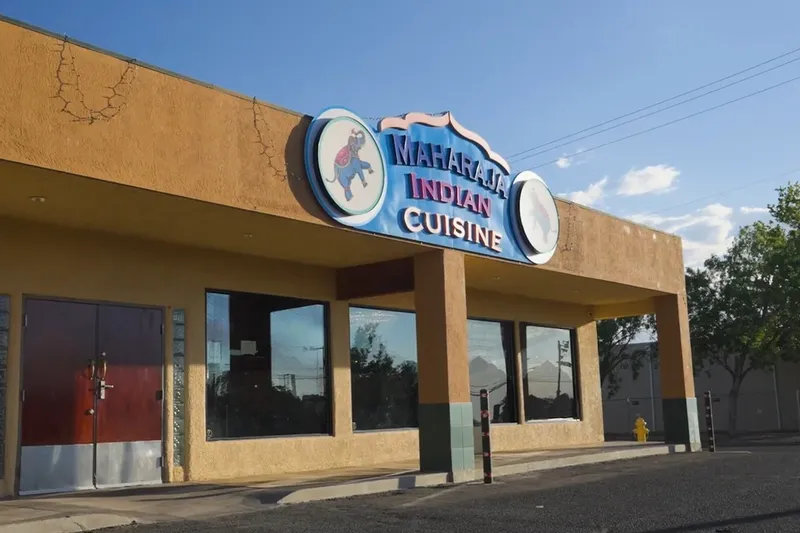Adobe-colored exterior of Maharaja Indian Cuisine on Lomas Boulevard, with its elephant sign above the entrance