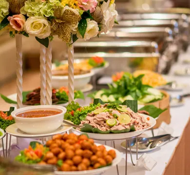 Buffet spread of Indian curries and dishes with a floral centerpiece at The Farmers Indian Restaurant