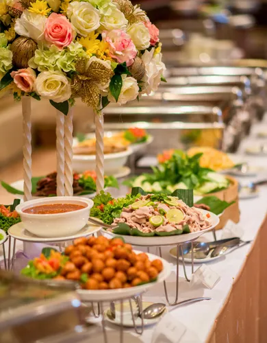 Buffet spread of Indian curries and dishes with a floral centerpiece at The Farmers Indian Restaurant
