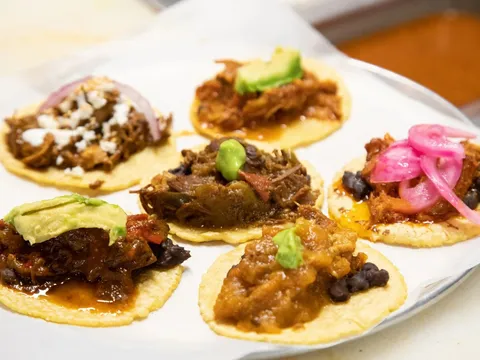 A platter of assorted tacos on corn tortillas at Guisados