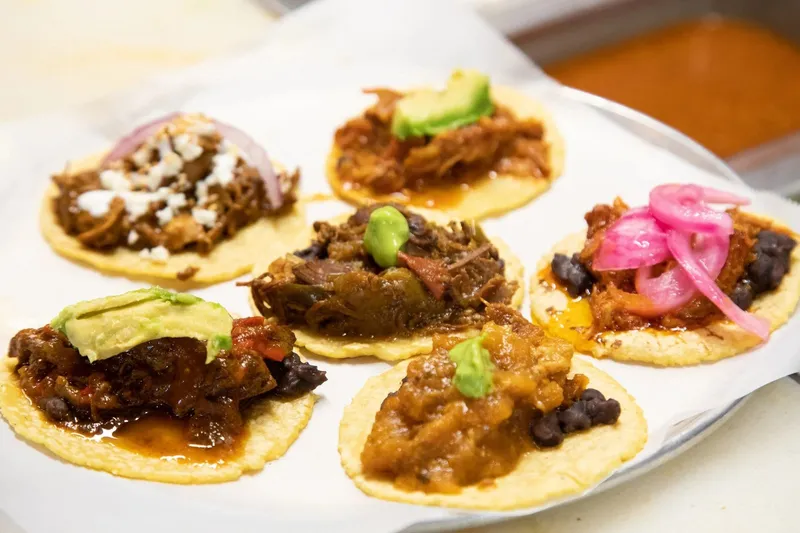A platter of assorted tacos on corn tortillas at Guisados