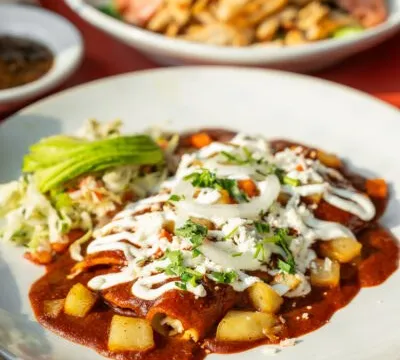 Enchiladas mexicanas topped with crema and queso fresco at Rosario's
