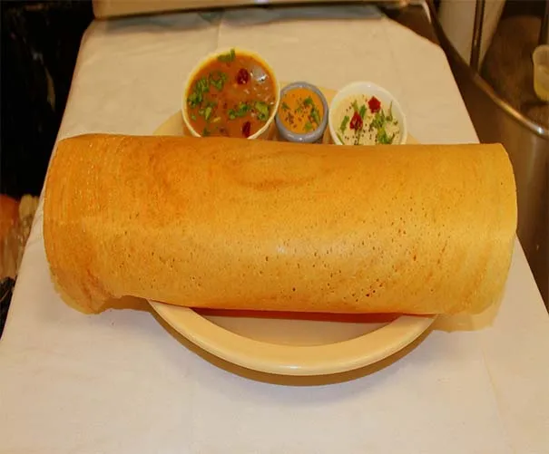 A large paper dosa served with sambar and two chutneys at Sri Dosa Place in Iselin.