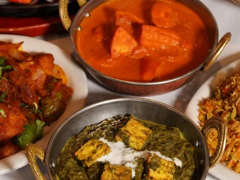 Curries, saag paneer and biryani in copper serving bowls at Mt. Everest
