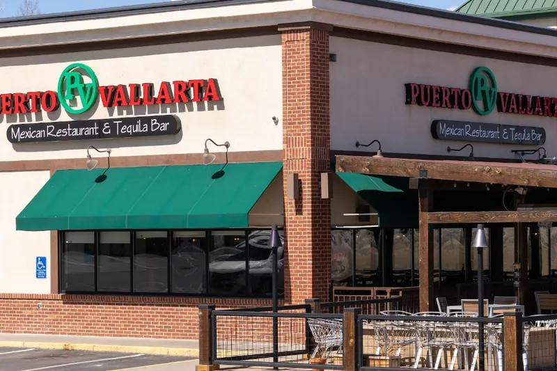 Exterior of Puerto Vallarta Mexican Restaurant & Tequila Bar with green awnings over the patio