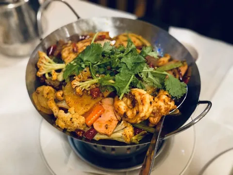 A sizzling griddled hot-and-spicy pot with chicken, cauliflower and dried chilies at Legend of Taste