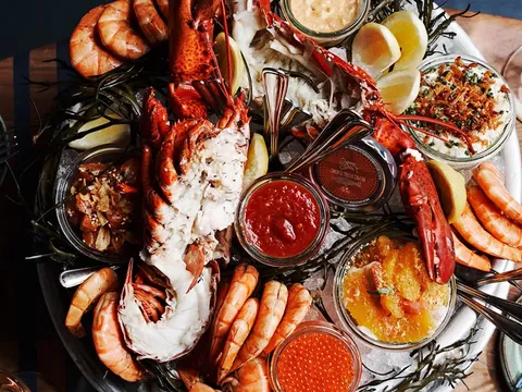 Seafood platter with lobster, shrimp, roe, lemons and sauces at The Optimist