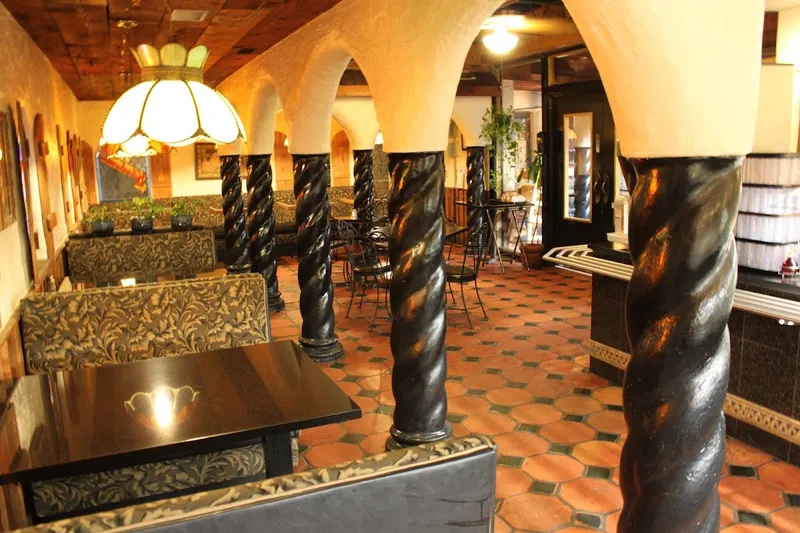 Dining room with carved black columns and arches at Kalachandji's in Dallas