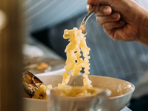 A forkful of pasta lifted from a bowl at Sorella