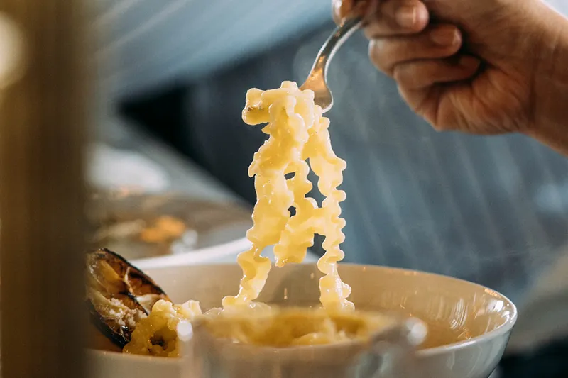 A forkful of pasta lifted from a bowl at Sorella