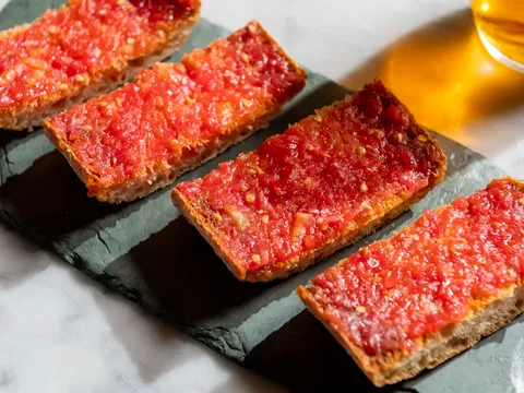 Pan con tomate on a slate board at Cúrate Bar de Tapas