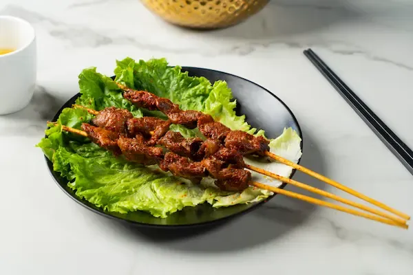 Grilled skewers on a bed of lettuce at Changsha Rice Noodle