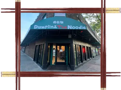 Corner storefront of Dumpling The Noodle in Seattle with a green awning over the entrance