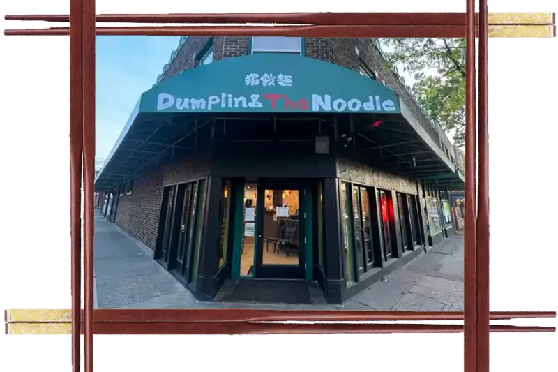 Corner storefront of Dumpling The Noodle in Seattle with a green awning over the entrance