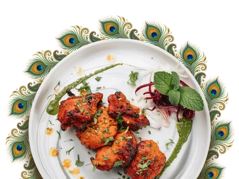Tandoori chicken plated on a peacock-feather-rimmed dish at Peacock Indian Bar & Grill