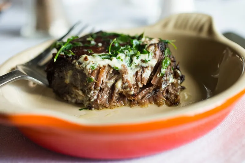 Braised beef short rib with salsa verde in a Le Creuset dish at Herbsaint