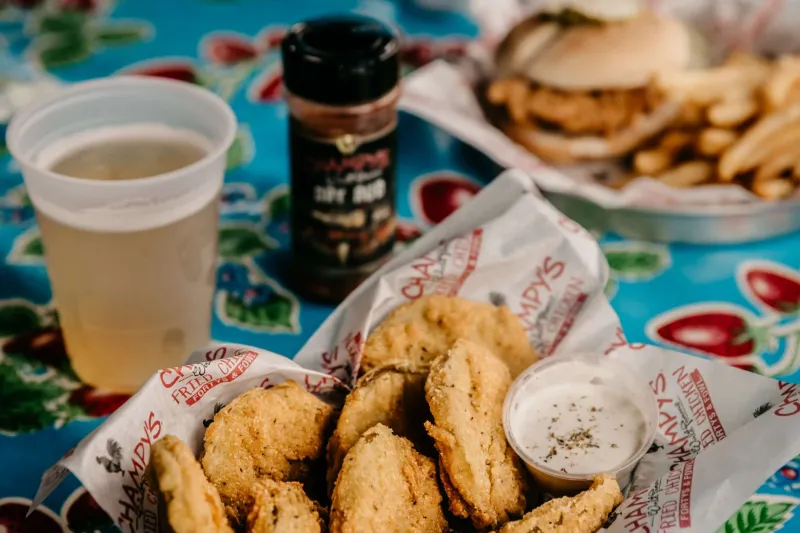 Fried pickles, a chicken sandwich, and a beer at Champy's Famous Fried Chicken