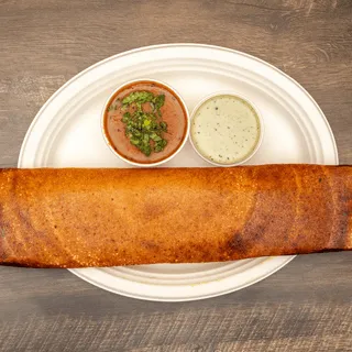 Mysore masala dosa on a plate with red and green chutneys at Sri Ganesh's Dosa House
