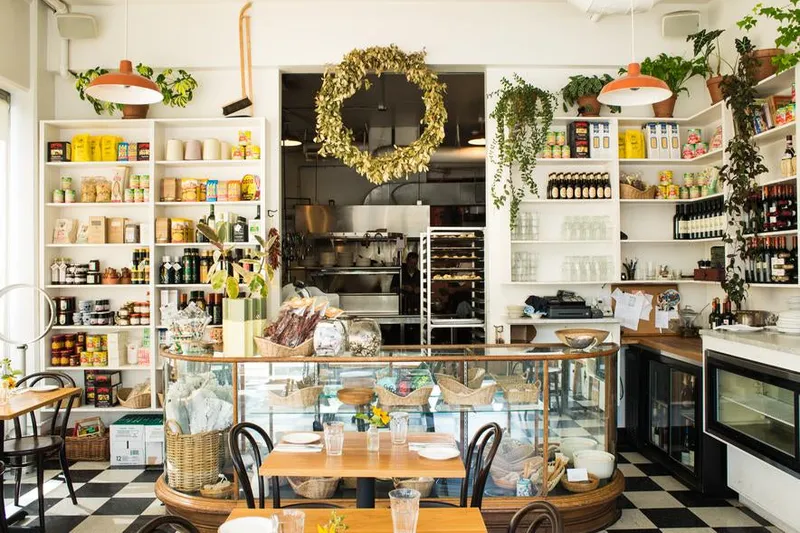 The bright dining room and market shelves inside Luce in Portland