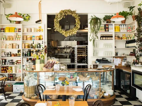 The bright dining room and market shelves inside Luce in Portland