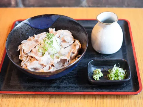 Cold Buta Shabu soba bowl with sliced pork and dipping sauce on a lacquer tray at Cocoron