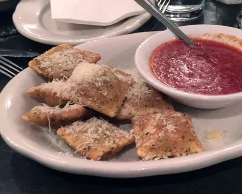 A plate of toasted ravioli with marinara dipping sauce at Cunetto House of Pasta