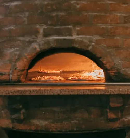 Pizza baking in the wood-fired oven at Pizzeria Bianco