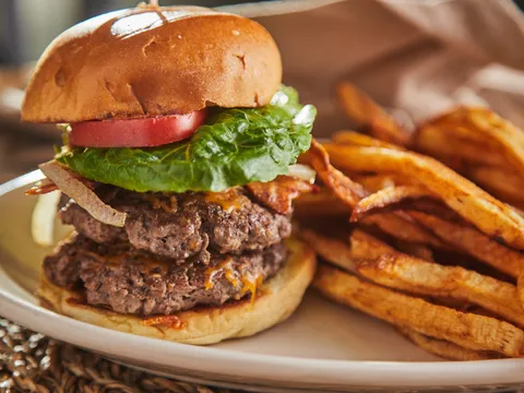 Double burger with lettuce and tomato served with hand-cut fries at The Brick