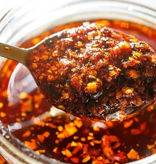 Spoonful of chili oil lifted from a jar at Yang Chow