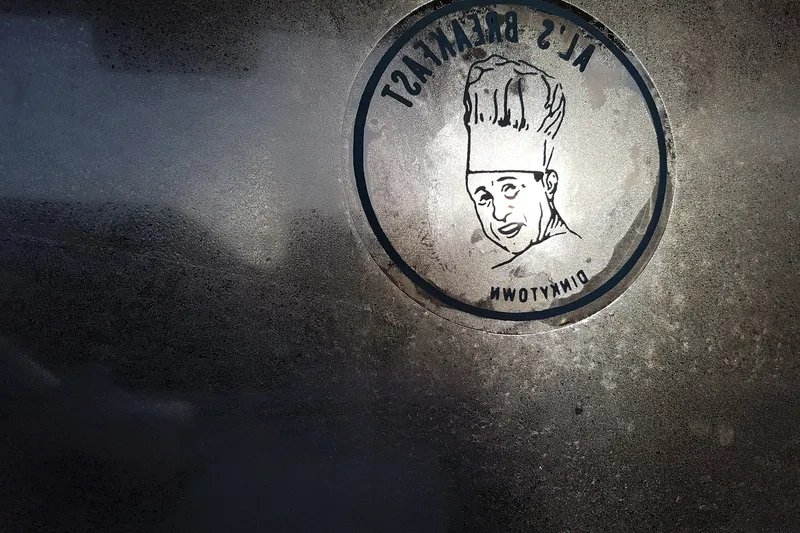 Al's Breakfast logo etched into the frosted front window of the Dinkytown diner in Minneapolis