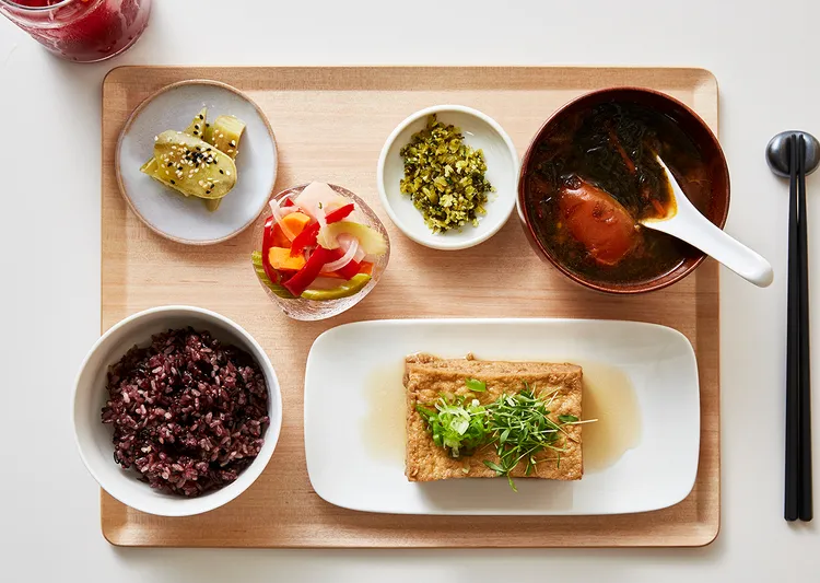 Overhead view of Yang's Kitchen tofu set meal with multigrain rice, miso soup, pickles, and small vegetable dishes