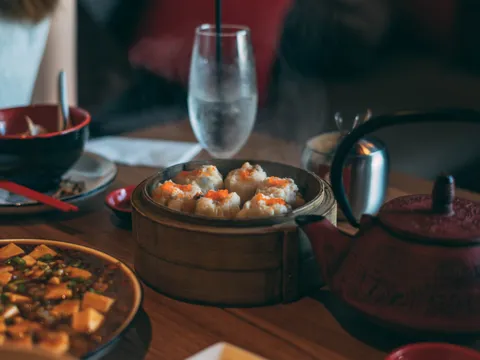 Dim sum steamer and mapo tofu on a table at Lai Hong Lounge