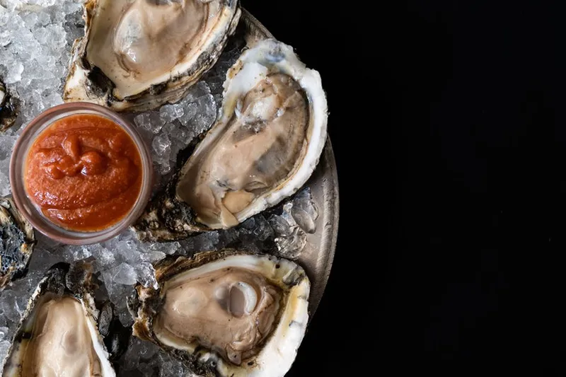 Oysters on ice with cocktail sauce at The Prime Rib