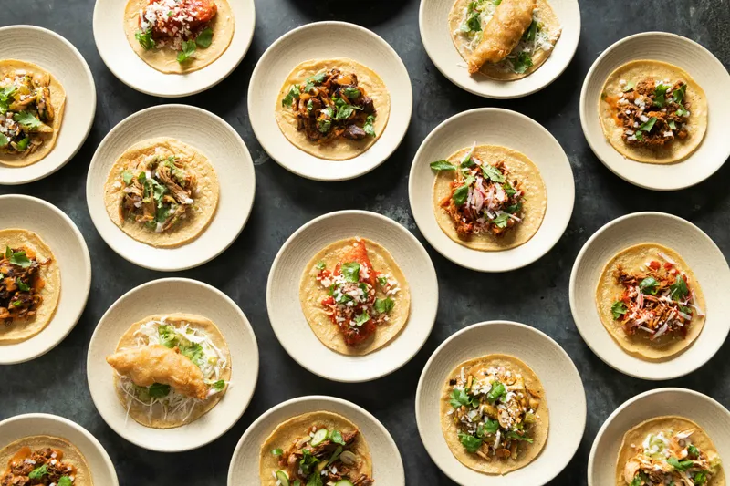 Overhead spread of assorted tacos on small plates at Empellón Taqueria & Bar in New York