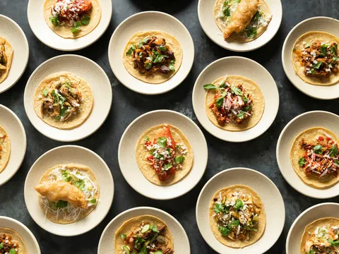 Overhead spread of assorted tacos on small plates at Empellón Taqueria & Bar in New York