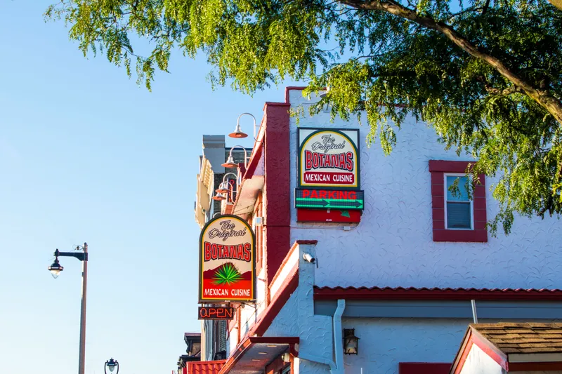 Exterior signage reading "The Original Botanas Mexican Cuisine" above the storefront of Botanas Restaurant on South 5th Street in Milwaukee